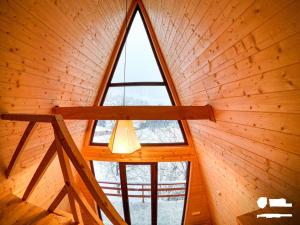 una grande finestra in una stanza con soffitto in legno di Paradiso Mestia a Mestia