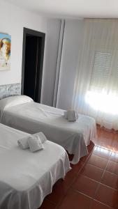 Postel nebo postele na pokoji v ubytování Hostal San Andrés