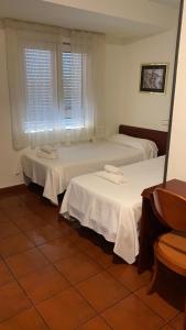 Postel nebo postele na pokoji v ubytování Hostal San Andrés