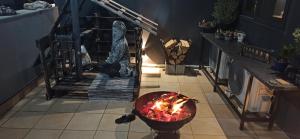 a room with a fire in a bowl on the floor at Accessible Luxury in Artemida