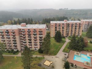 an aerial view of a large apartment building with a pool at Fewo-Harz-Uraub in Altenau