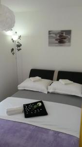 a room with two beds with a tray on it at Room near the center in Split