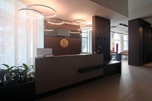 an office lobby with a reception desk and potted plants at Hotel Santin in Pordenone