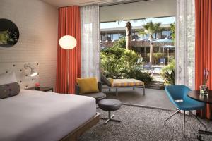 a hotel room with a bed and a patio at Hotel Valley Ho in Scottsdale