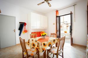a dining room with a table and chairs at Casa Viga in Tre Fontane +4 photos