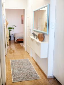 a bathroom with a sink and a mirror at Apartament Sunset Boulevard z tarasem dla 4 gości in Gdynia