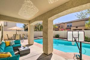 a patio with a basketball hoop and a swimming pool at Game Room and Pool Spacious Queen Creek Home! in Queen Creek