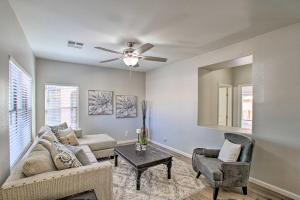 a living room with a couch and a ceiling fan at Game Room and Pool Spacious Queen Creek Home! in Queen Creek