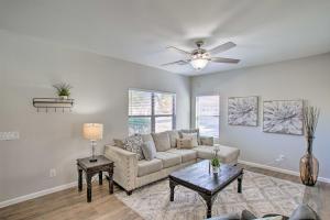 a living room with a couch and a ceiling fan at Game Room and Pool Spacious Queen Creek Home! in Queen Creek