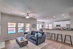 a living room with a couch and a kitchen at Game Room and Pool Spacious Queen Creek Home! in Queen Creek