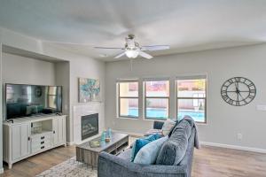 a living room with a couch and a ceiling fan at Game Room and Pool Spacious Queen Creek Home! in Queen Creek
