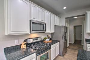 a kitchen with white cabinets and a stove top oven at Game Room and Pool Spacious Queen Creek Home! in Queen Creek