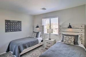 a bedroom with two beds and a window at Game Room and Pool Spacious Queen Creek Home! in Queen Creek