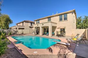 a swimming pool in front of a house at Game Room and Pool Spacious Queen Creek Home! in Queen Creek