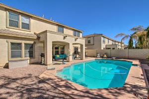 a swimming pool in front of a house at Game Room and Pool Spacious Queen Creek Home! in Queen Creek
