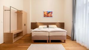 Posteľ alebo postele v izbe v ubytovaní Domus Peregrini Apartmanok