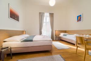 Posteľ alebo postele v izbe v ubytovaní Domus Peregrini Apartmanok