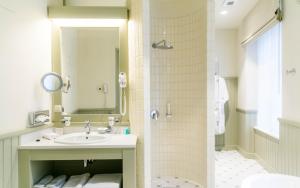 a bathroom with a sink and a shower at Antonius Hotel in Tartu