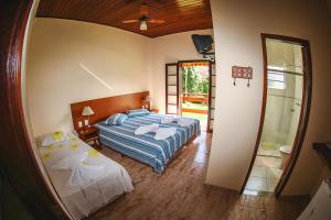 Ένα ή περισσότερα κρεβάτια σε δωμάτιο στο Pousada Pedra da Mina
