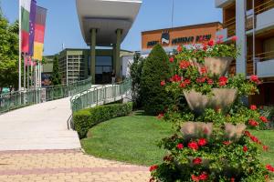 a walkway in front of a building with flowers at Nessebar Beach Hotel in Sunny Beach