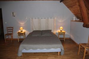 1 dormitorio con 1 cama con 2 sillas y 2 lámparas en chevrerie de la huberdiere, en Liesville-sur-Douve