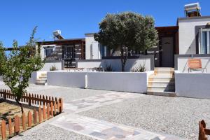 a house with a fence in front of it at Kochylari Apartments in Kefalos