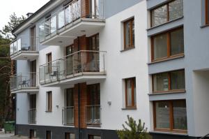 an apartment building with balconies and windows at Apartamenty Marina Jastrzębia Góra in Jastrzębia Góra