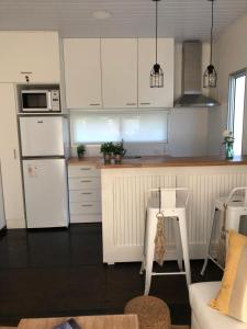 a kitchen with white cabinets and a white refrigerator at Hacienda WF - Casa 2 in Punta del Este