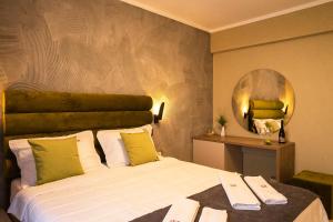 a bedroom with a large bed and a mirror at Lotus Exclusive in Mamaia Sat/Năvodari