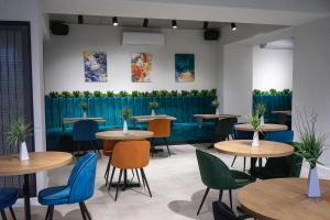 a restaurant with tables and chairs and a fence at Lotus Exclusive in Mamaia Sat/Năvodari +30 photos