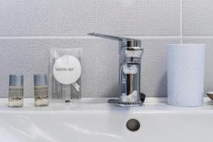 a bathroom sink with a toothbrush and cosmetics on it at Lotus Exclusive in Mamaia Sat/Năvodari