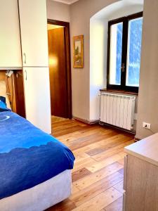 a bedroom with a bed and a wooden floor at Casa Paradiso in Vione