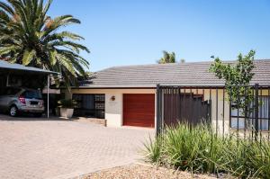 a house with a car parked in front of it at La Grâce, Durbanville in Cape Town