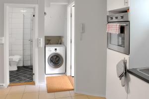 a white laundry room with a washer and dryer at HF Apartments in Bergen