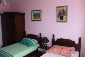 a bedroom with two beds and two pictures on the wall at Summer house in Novalja in Novalja