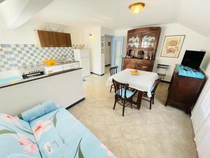 a kitchen and a living room with a table in a room at Blue Sky apartment - Levanto, 5 Terre in Levanto