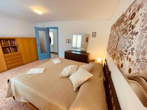 a bedroom with a large bed with two pillows at Blue Sky apartment - Levanto, 5 Terre in Levanto