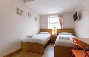 A bed or beds in a room at Harrow Rd Rooms by DC London Rooms