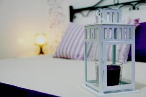 a white cage sitting on a table next to a bed at Mamma Lucia in Sorrento