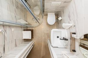 a bathroom with a toilet and a sink at Sakura_INN Palanga in Palanga +124 photos