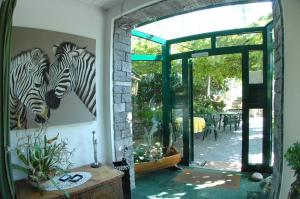 a room with a painting of zebras on the wall at Osteria Garni Americana in Cadempino