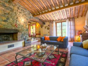 a living room with a couch and a fireplace at Holiday Home Podere Gabruccino by Interhome in Riparbella