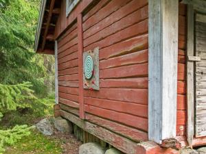 a house with a sign on the side of it at Holiday Home Santerin torppa by Interhome in Iitti