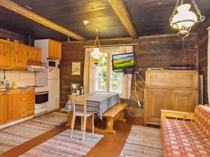 a kitchen with a table and a dining room at Holiday Home Santerin torppa by Interhome in Iitti