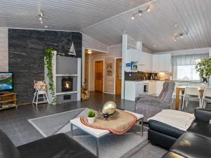 ein Wohnzimmer mit einem Sofa und einem Tisch in der Unterkunft Holiday Home Hot pool cottage laurinranta by Interhome in Ihamaniemi