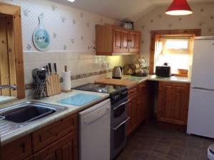 a kitchen with a sink and a stove top oven at Holiday Home Leduckie by Interhome in Riechip