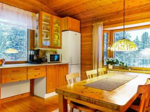 a kitchen with a wooden table and a dining room at Holiday Home Riekkotupa by Interhome in Enontekiö