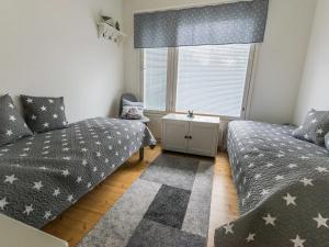 een slaapkamer met 2 bedden en een raam bij Holiday Home Salmiranta by Interhome in Jämijärvi