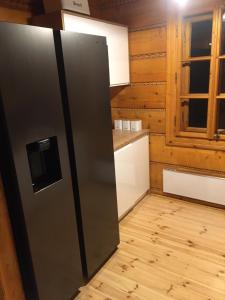 a kitchen with a refrigerator and a window at SkiBajkowa Chata in Szczyrk +35 photos