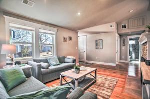 a living room with couches and a table at Walk to Shore: Updated Buzzards Bay Cottage! in Buzzards Bay